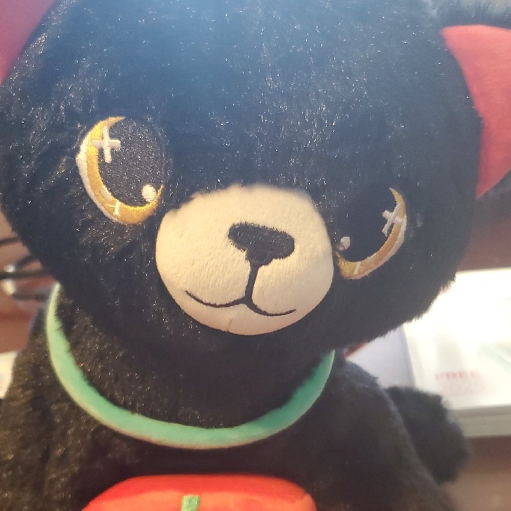 Black Plush Toy with Red and Green Accents